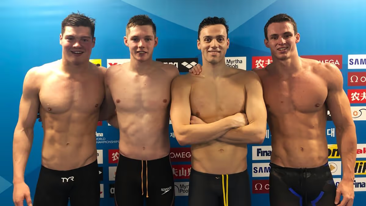 Four competitive swimmers at a championship meet